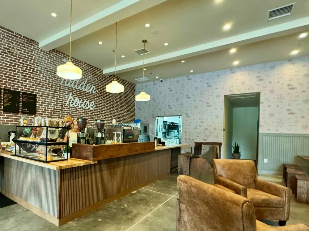 Hidden House Coffee interior with pendant and recessed lighting above the coffee bar