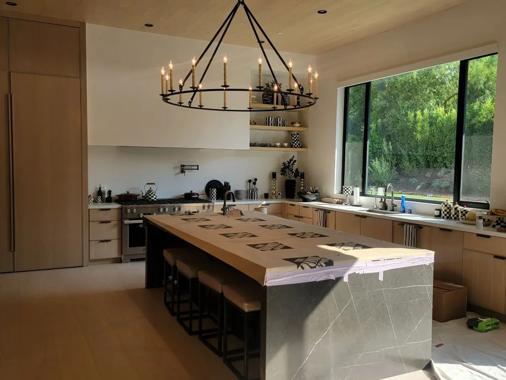 Residential kitchen with island and decorative pendant lighting